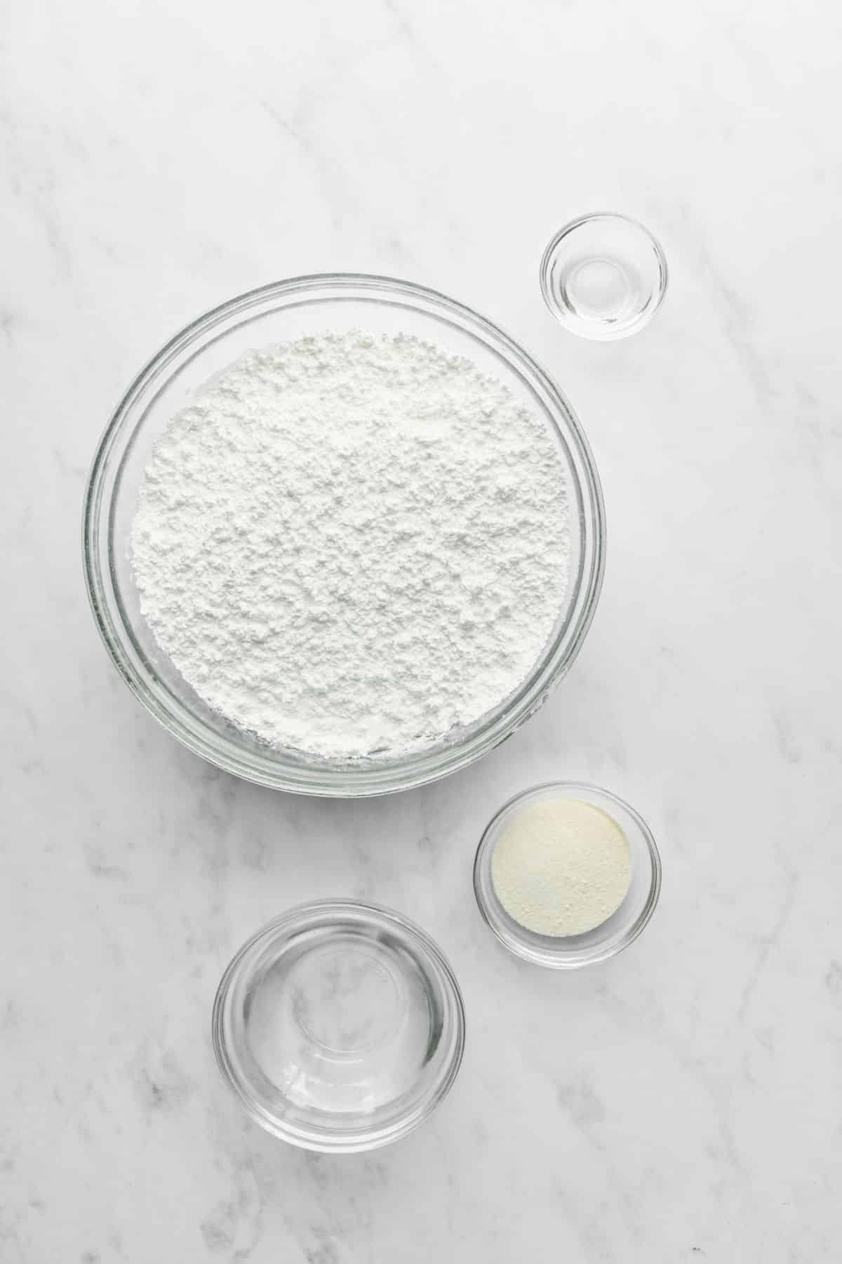 Ingredients for royal icing in glass dishes.