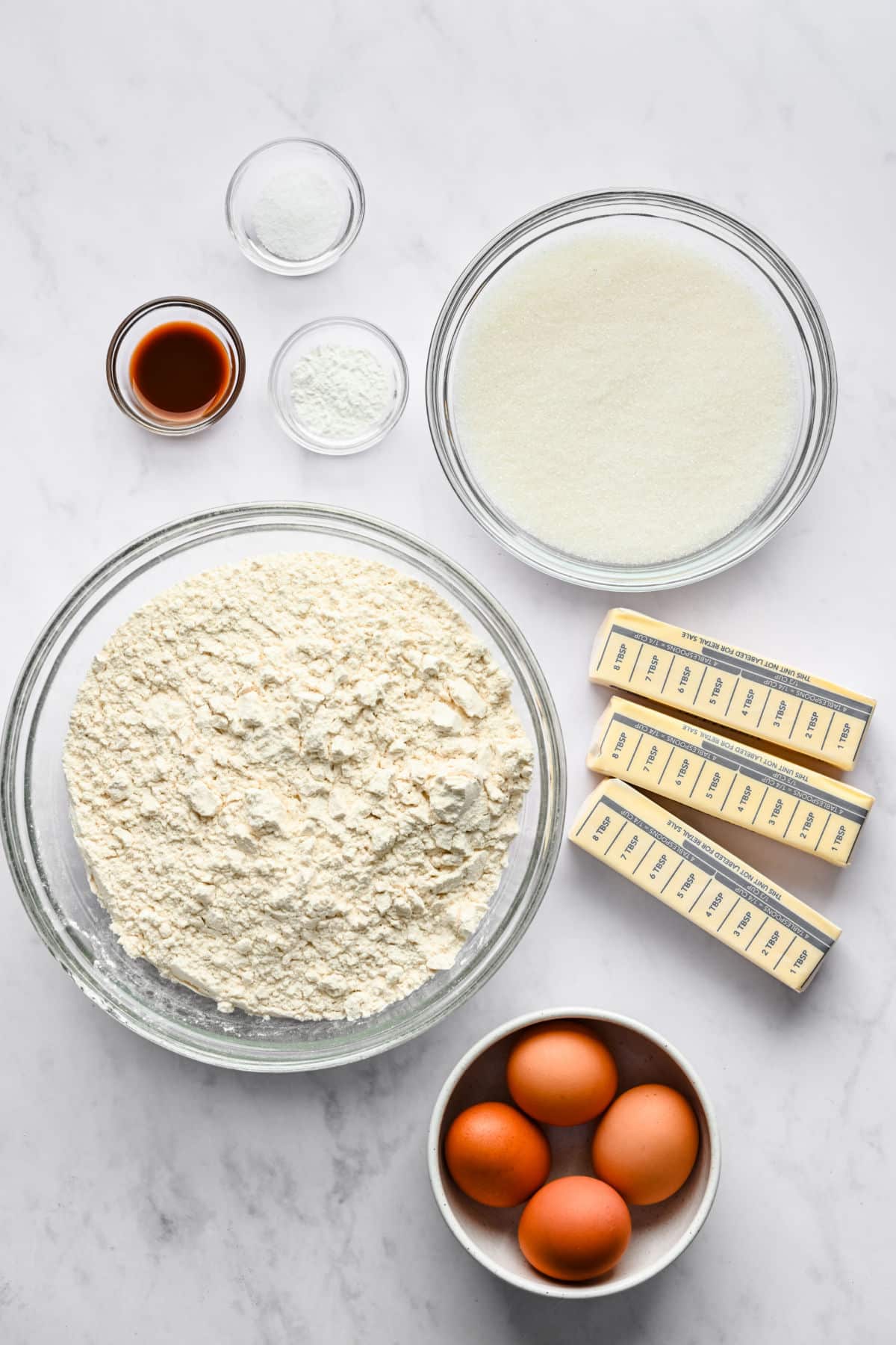Ingredients for cut out sugar cookies in glass dishes.
