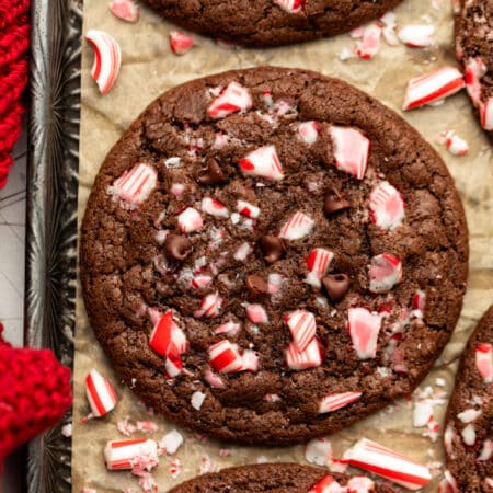 Chocolate peppermint cookies on a brown parchment lined vintage baking tray.