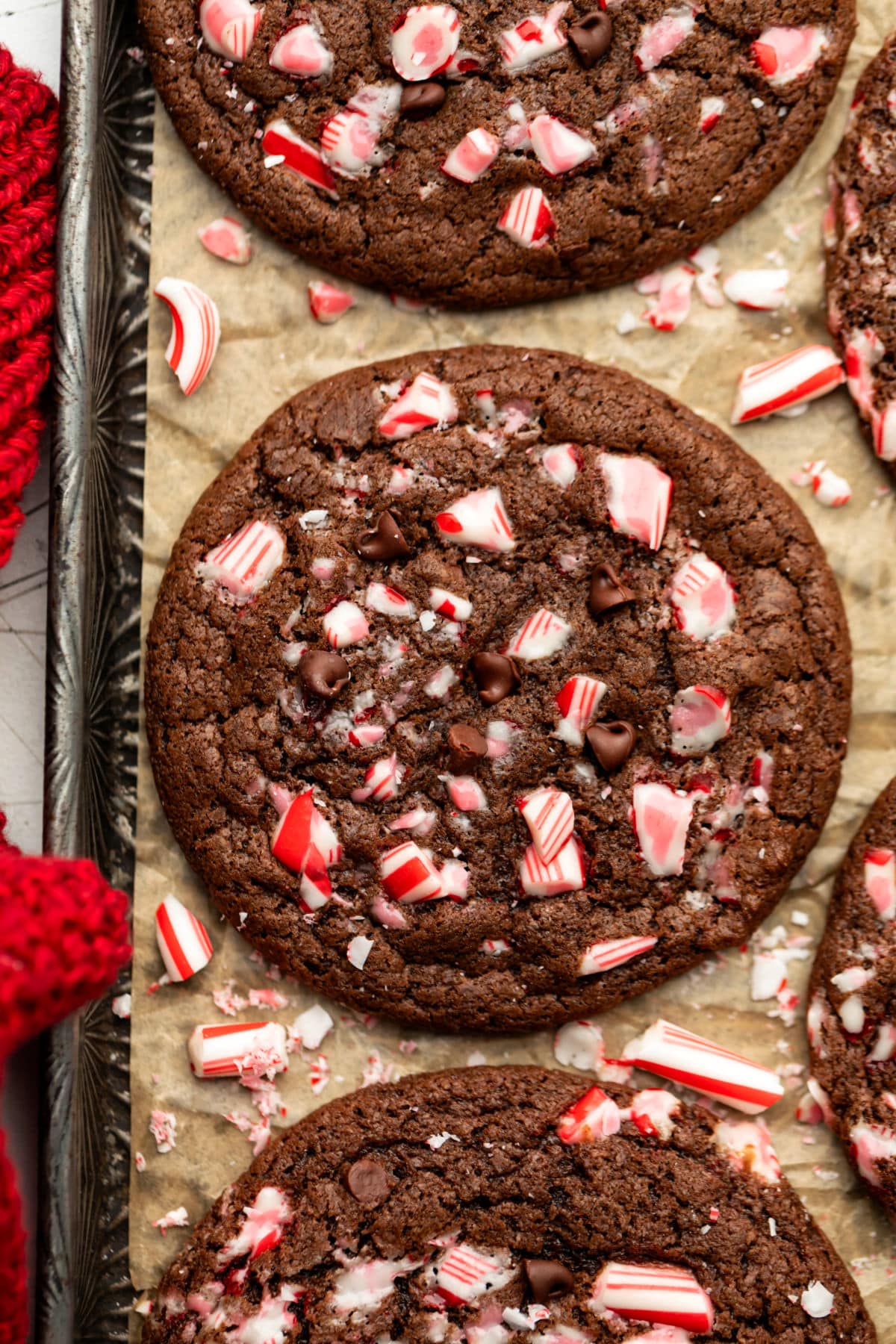 Chocolate peppermint cookies on a brown parchment lined vintage baking tray.