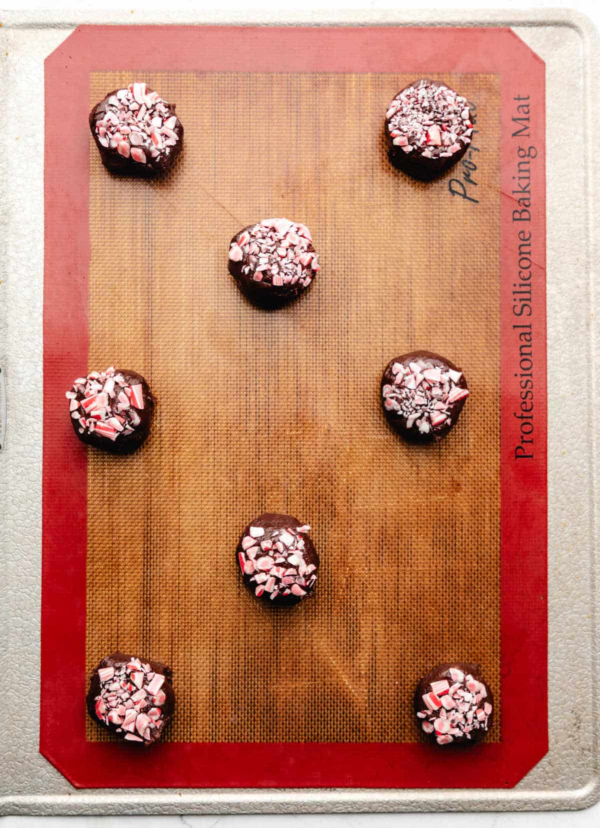 Chocolate peppermint cookie dough on a baking sheet. 
