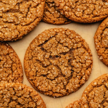 Stacks of chewy ginger molasses cookies around a cookie in the center.