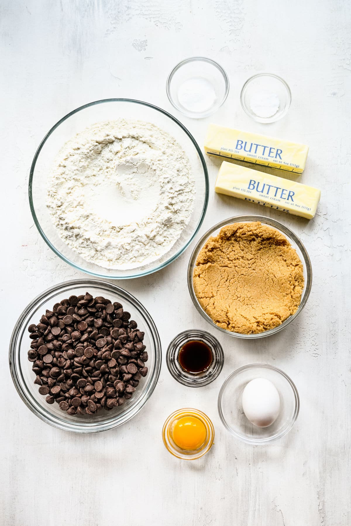 Ingredients for chewy chocolate chip cookies in dishes. 