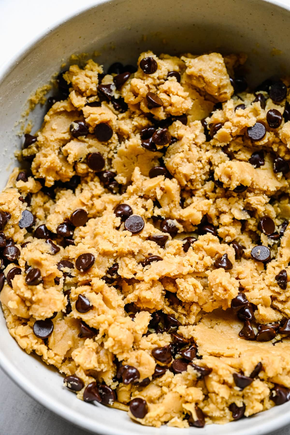 Chewy chocolate chip cookie dough in a mixing bowl. 