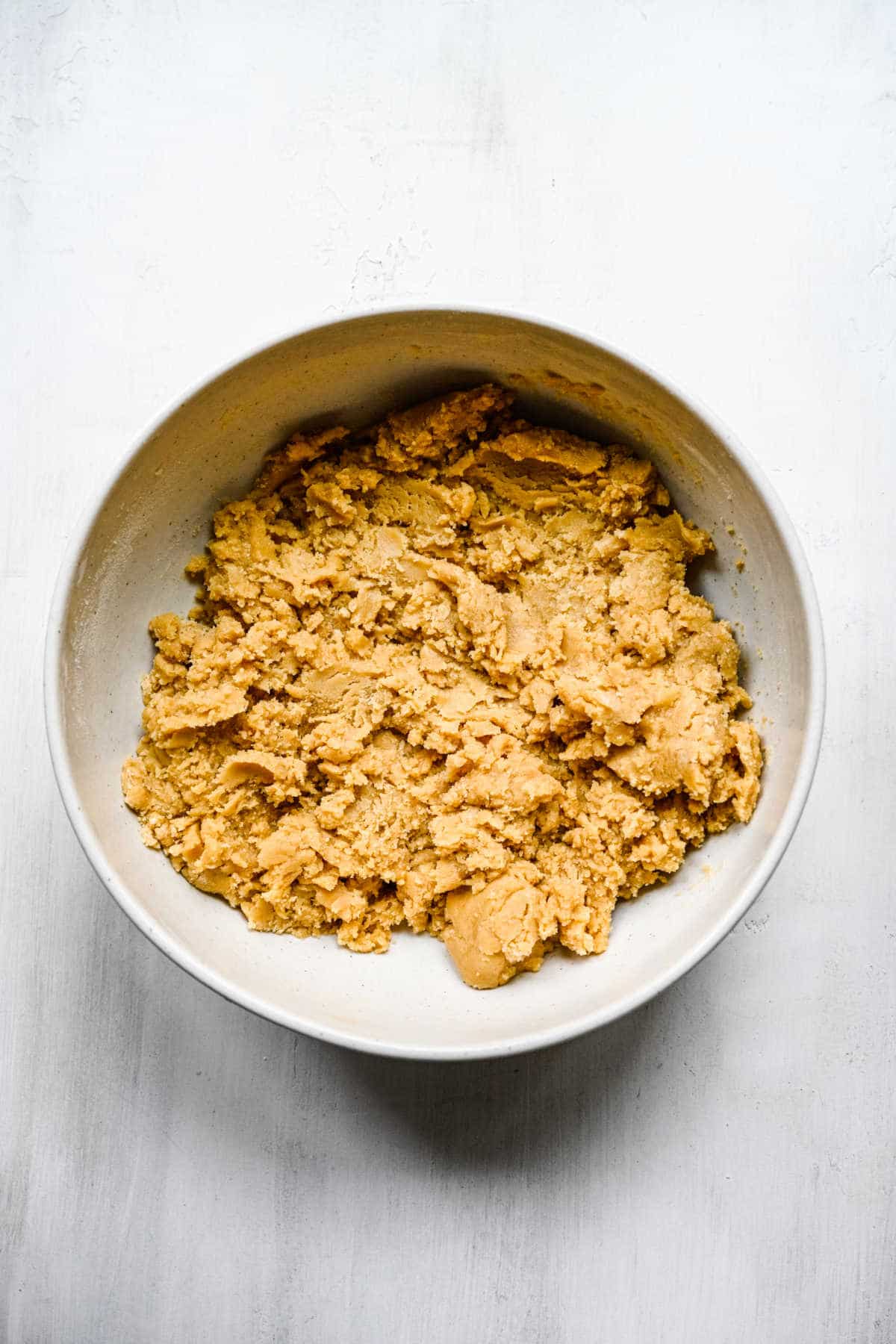 Dry ingredients stirred into butter mixture in a mixing bowl. 