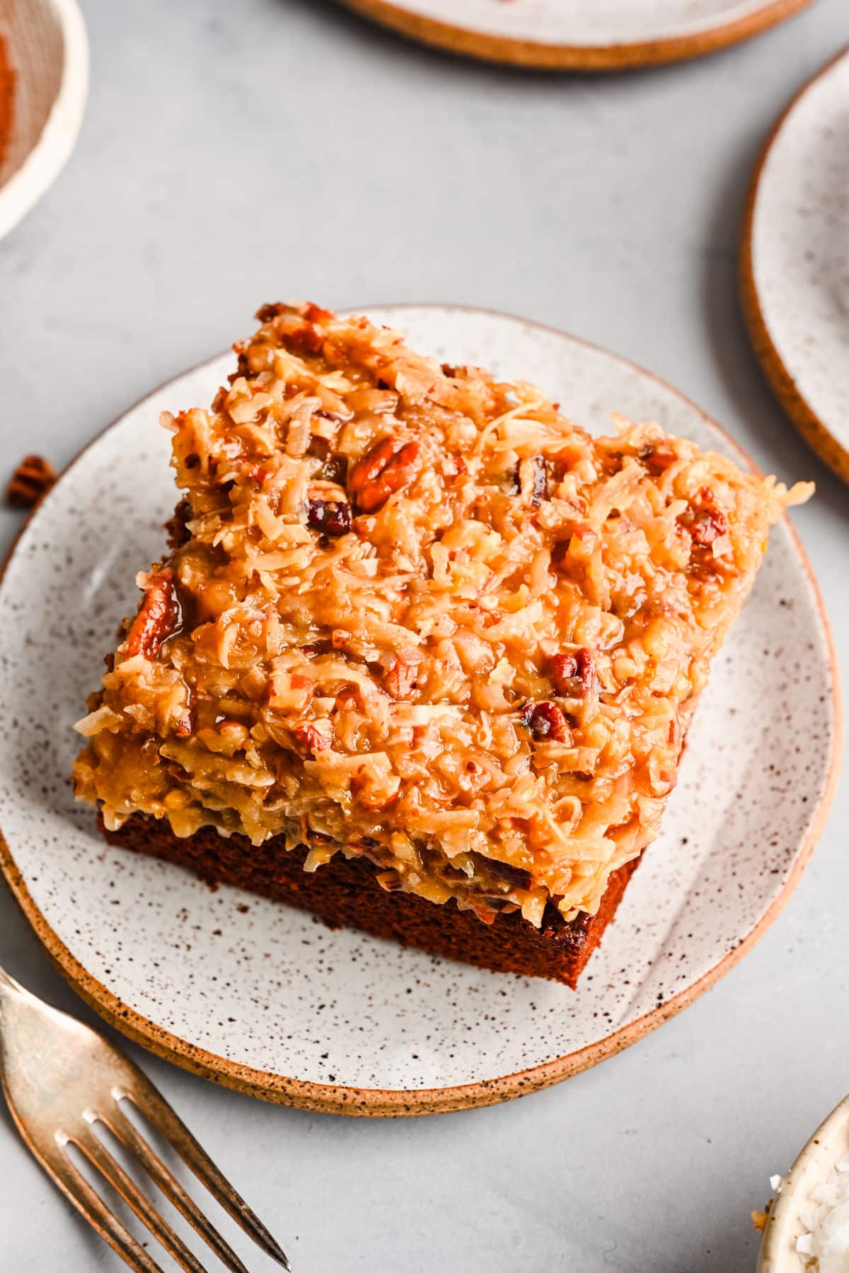 A slice of German chocolate sheet cake on a plate.