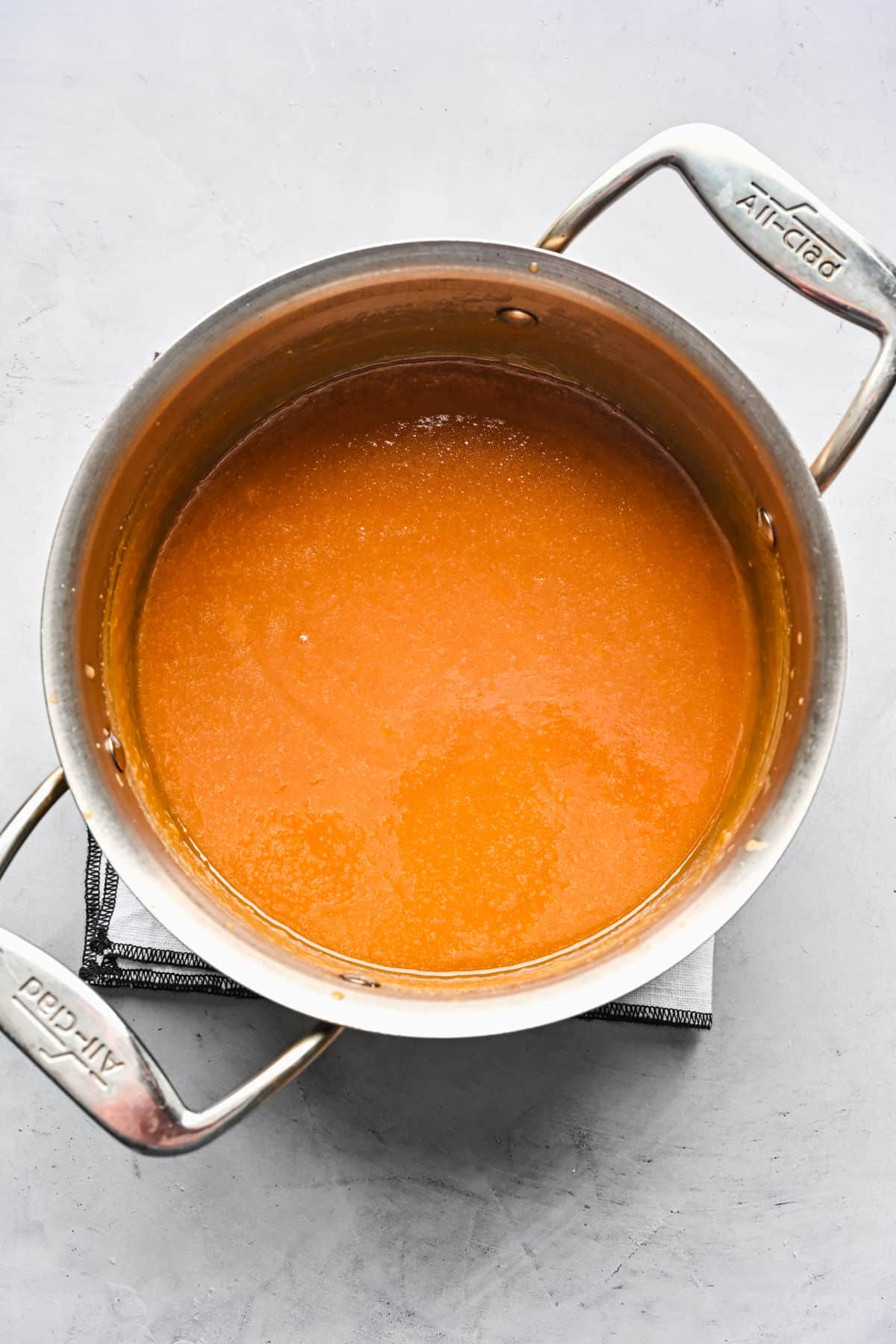 Brown sugar and egg yolks whisked together in a pot.