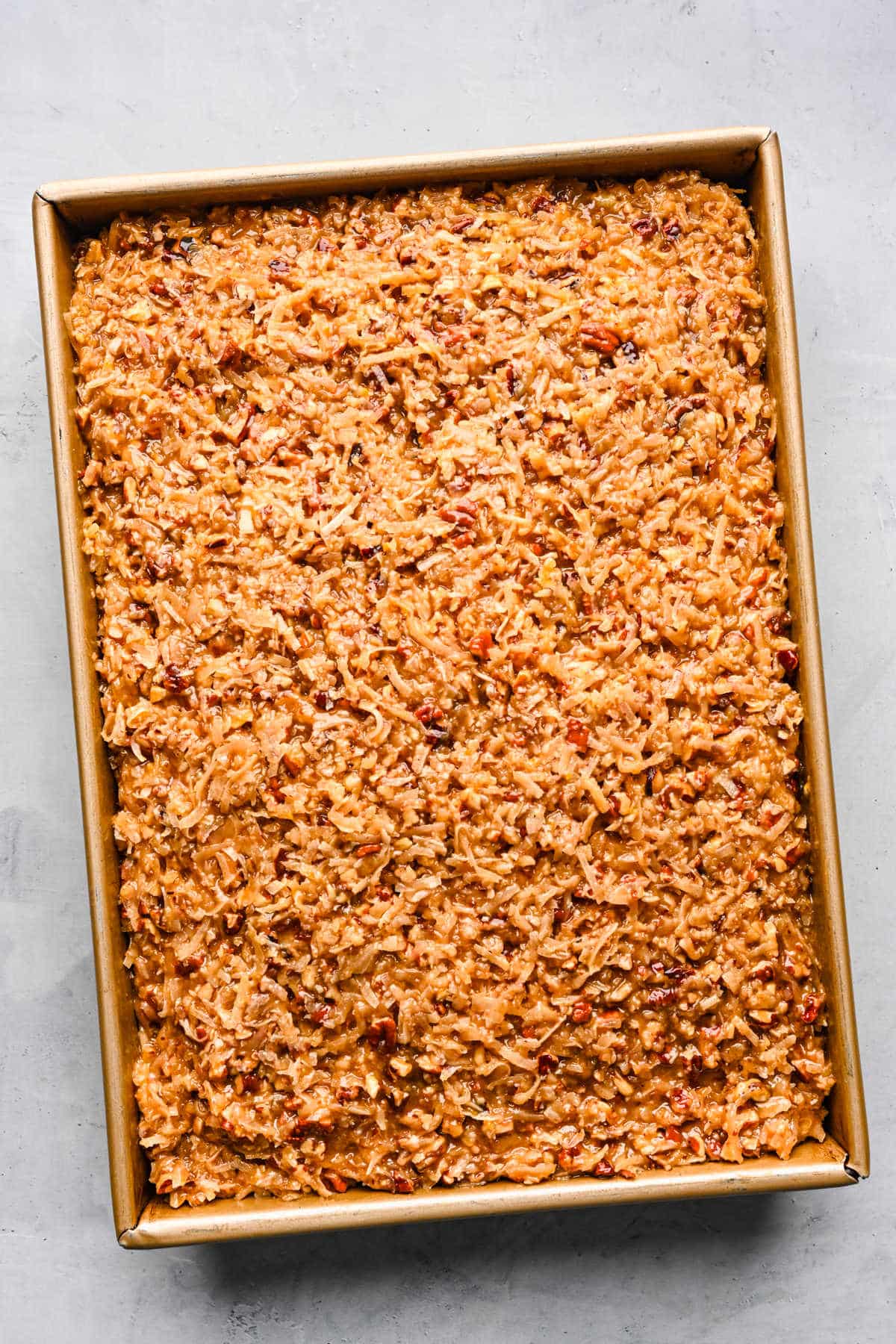 Frosted German chocolate cake in a pan.