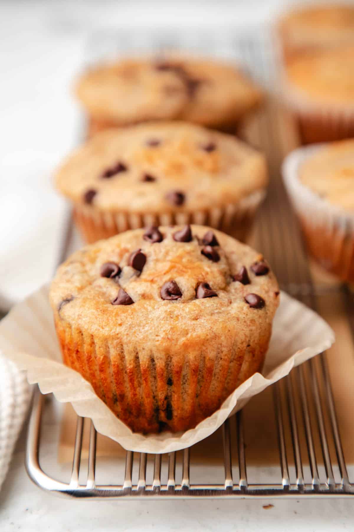 A Greek yogurt muffin with the muffin liner pulled down on it. 