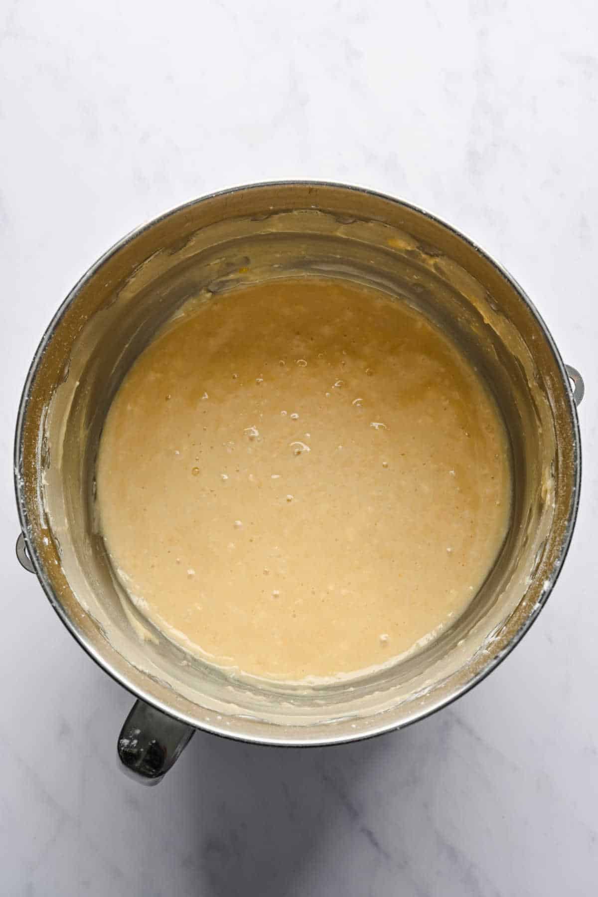 Greek yogurt pound cake batter in a silver mixing bowl. 