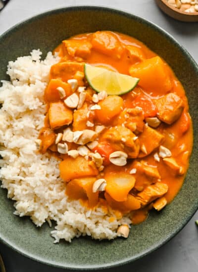 A dish of chicken massaman curry over sticky rice.