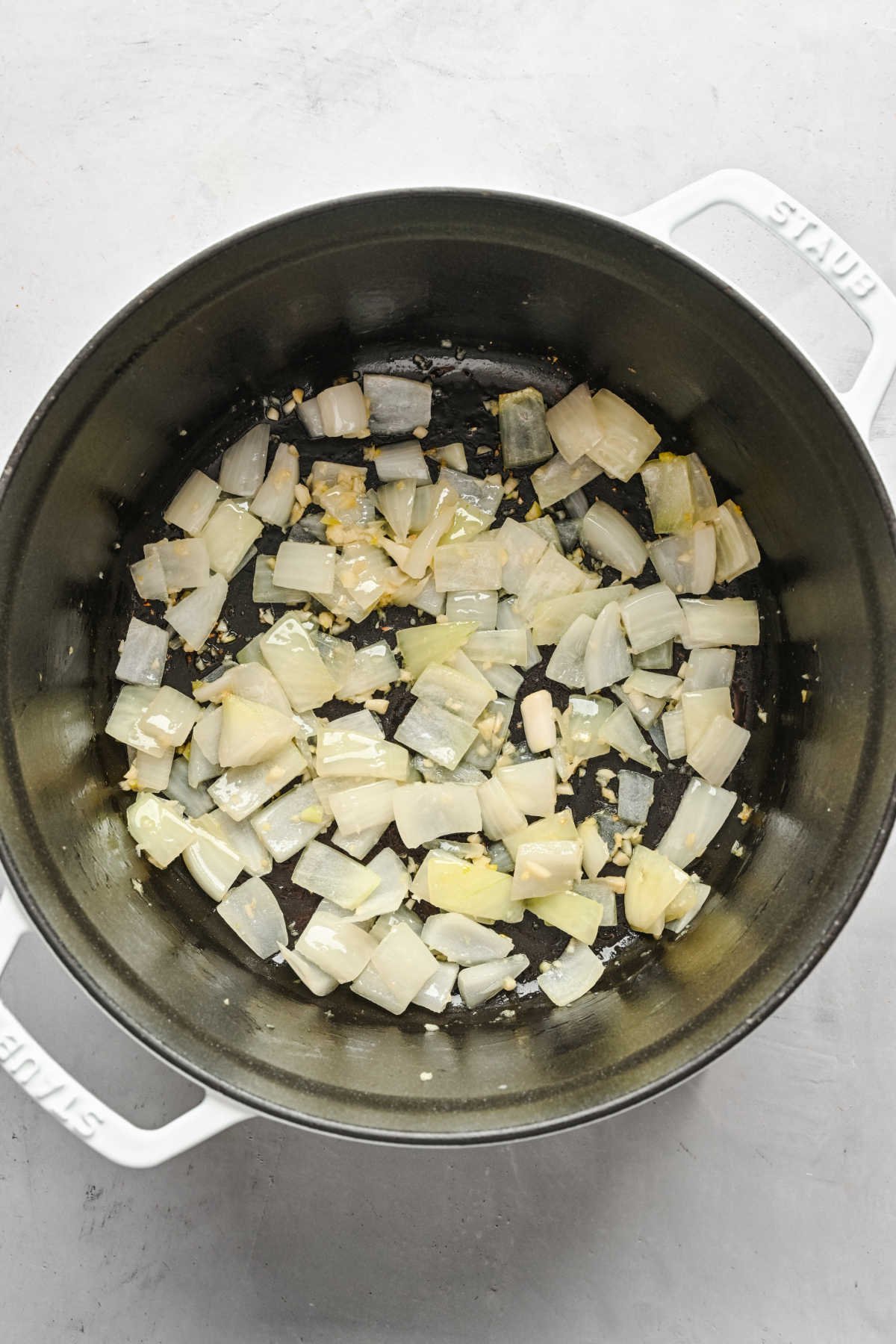 Onions ginger and garlic sautéing in a pot.