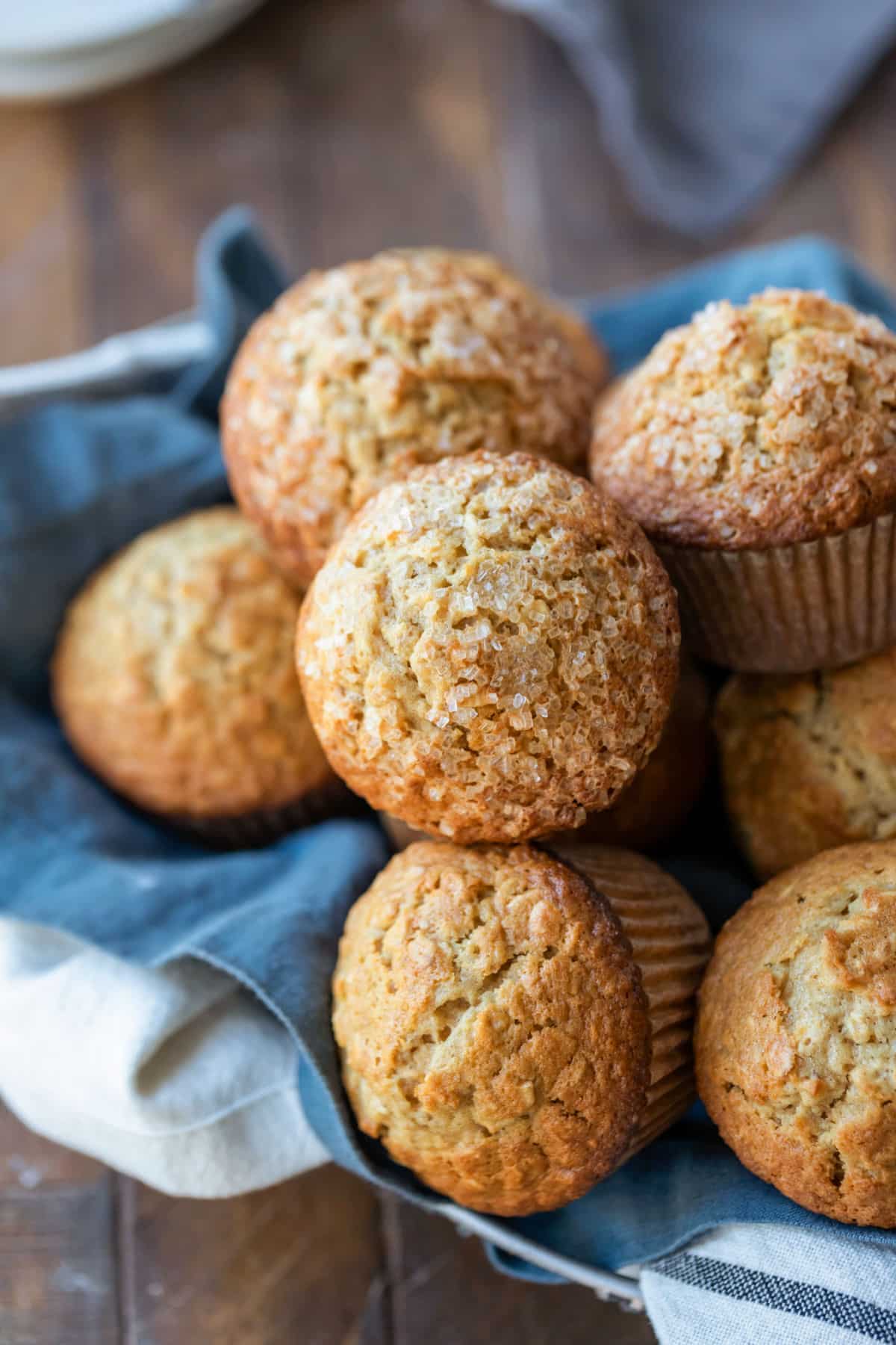 A stack of maple brown sugar oatmeal muffins in a bread basket. 