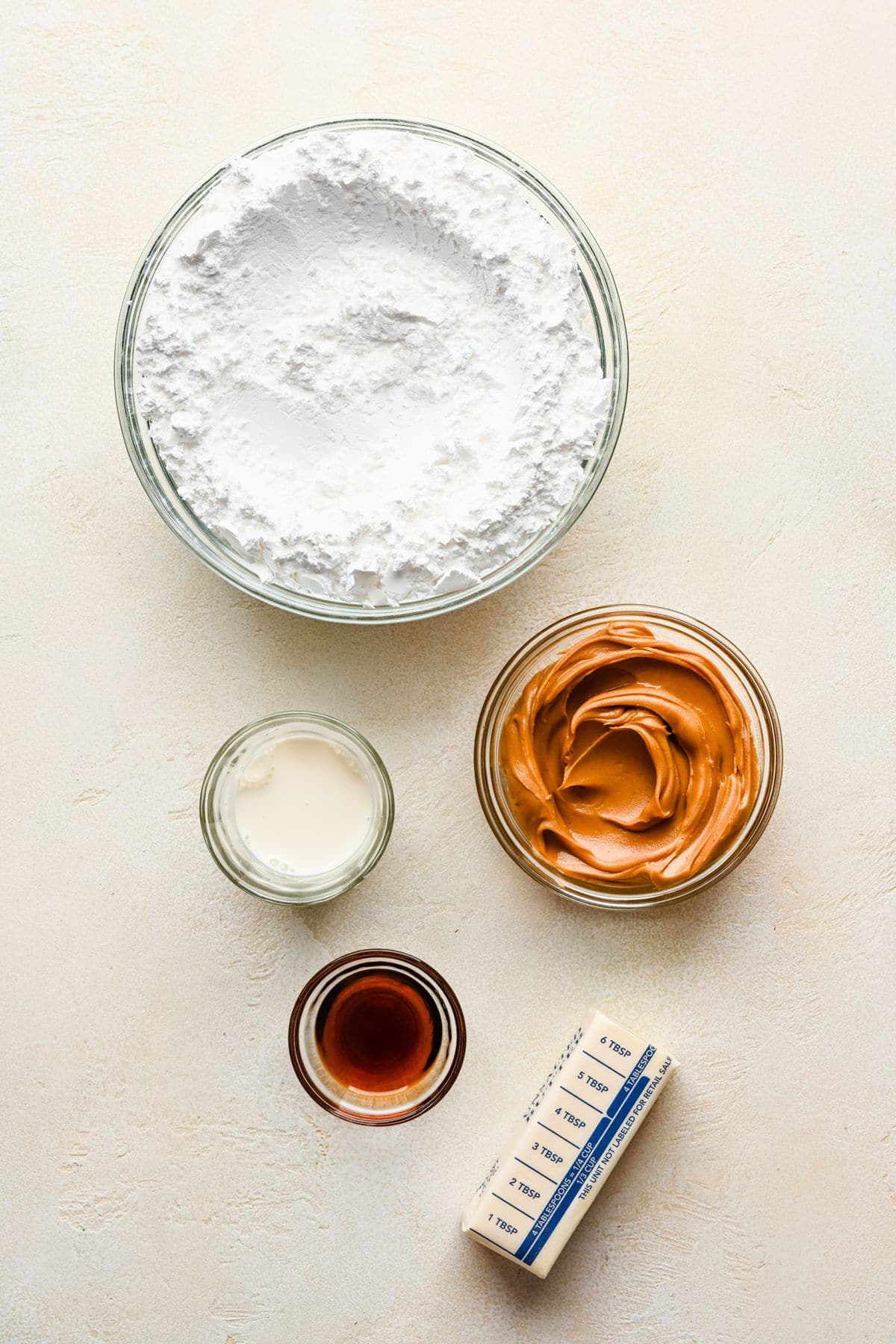 Ingredients for peanut butter frosting in dishes.