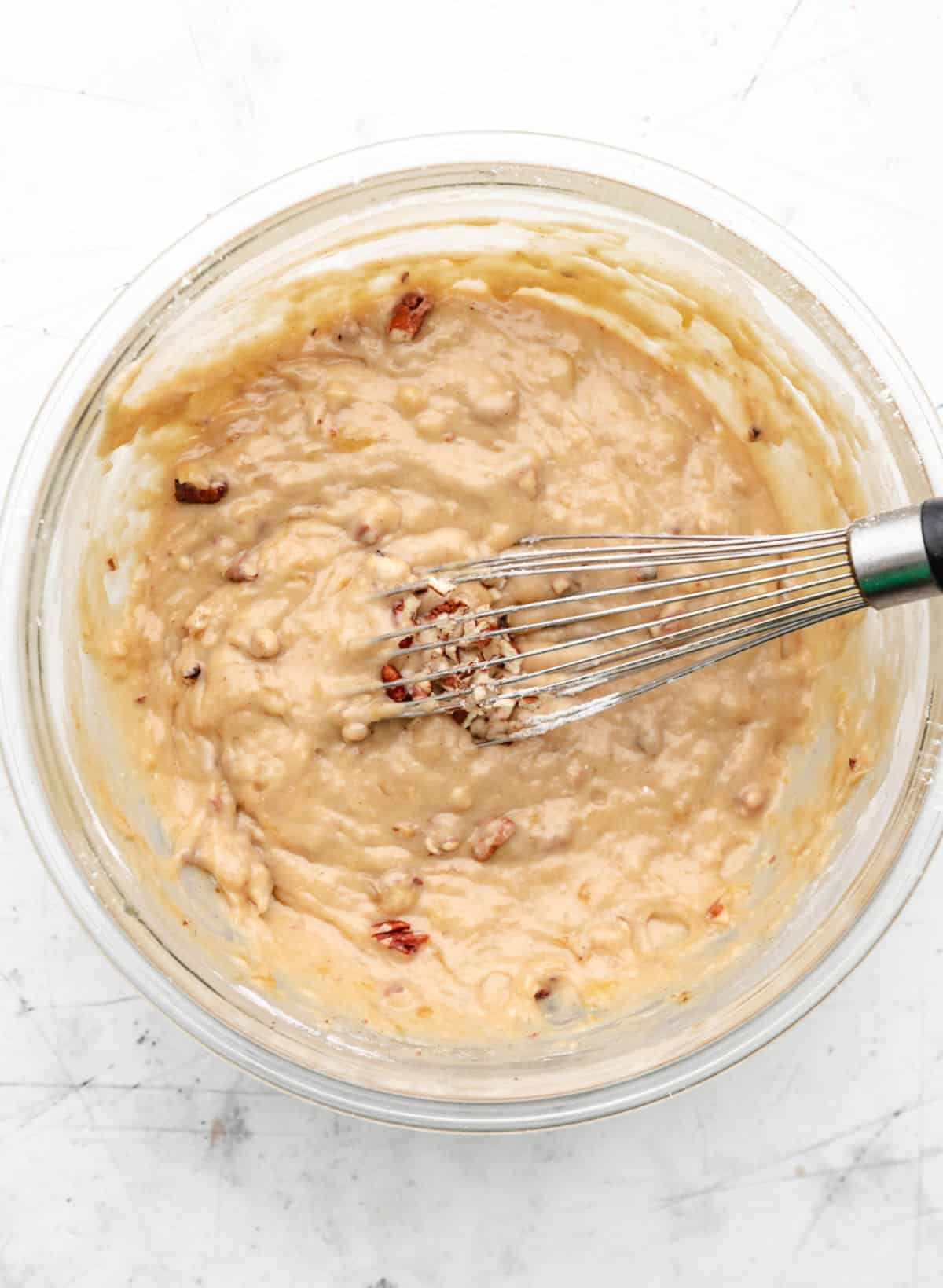 Nuts whisked into banana nut bread batter. 