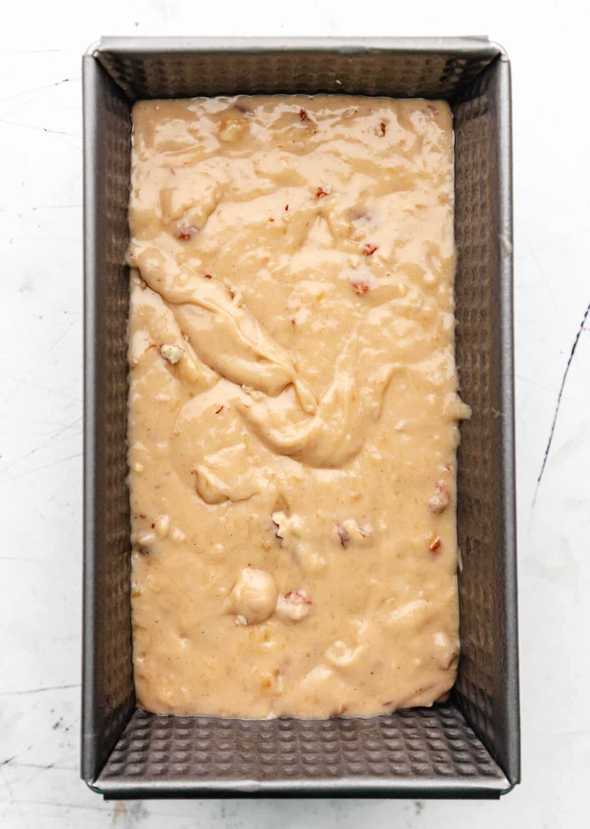 Banana nut bread batter in a loaf pan.