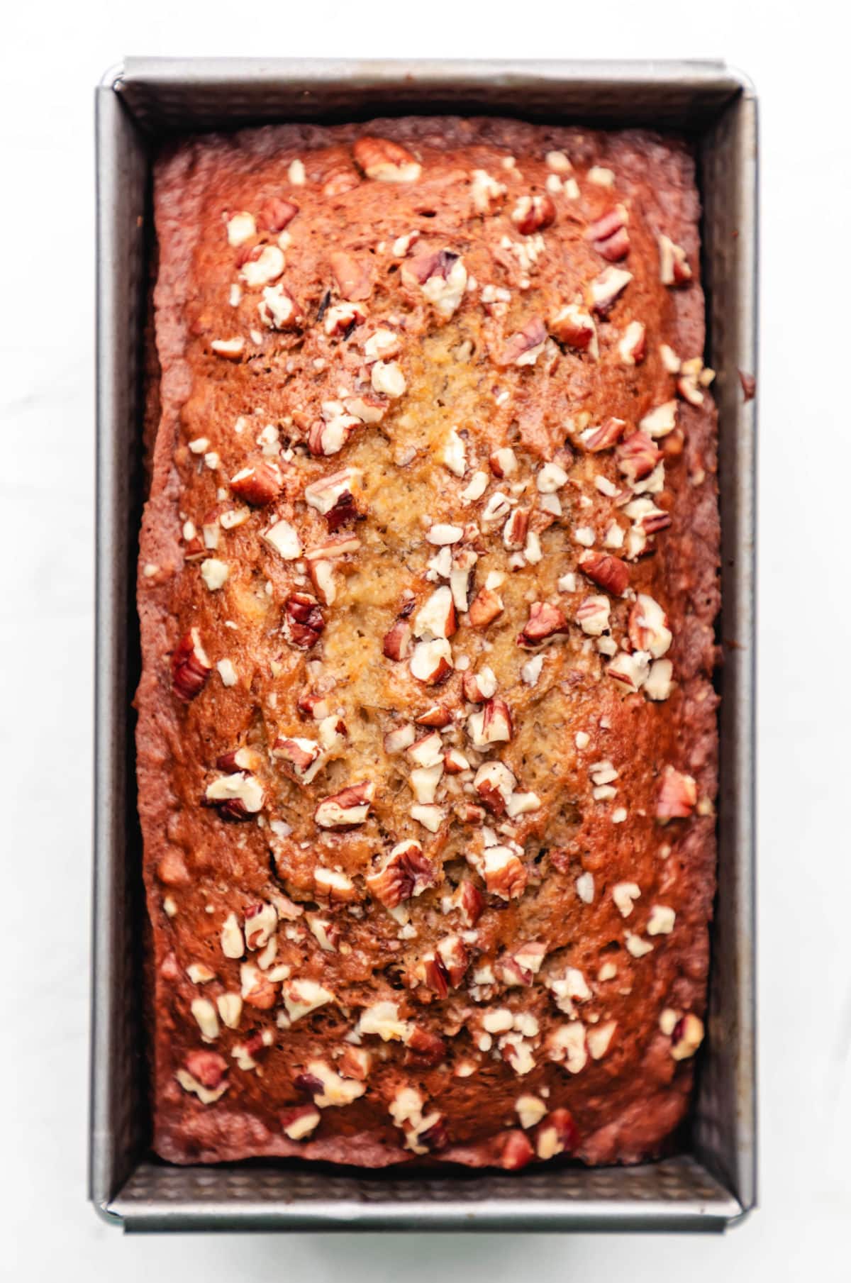 A loaf of banana nut bread in the baking pan.
