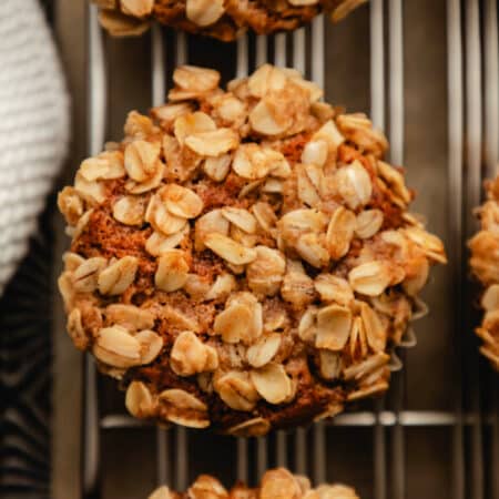 Three banana oatmeal muffins in a vintage baking pan.