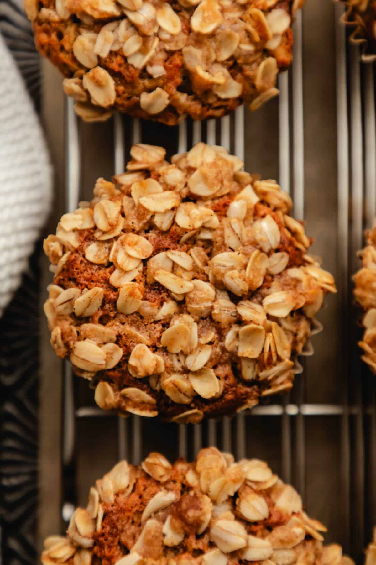 Three banana oatmeal muffins in a vintage baking pan.