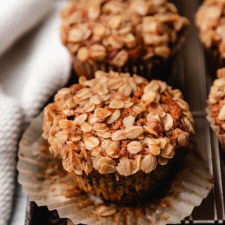A banana oatmeal muffin with the wrapper turned down.