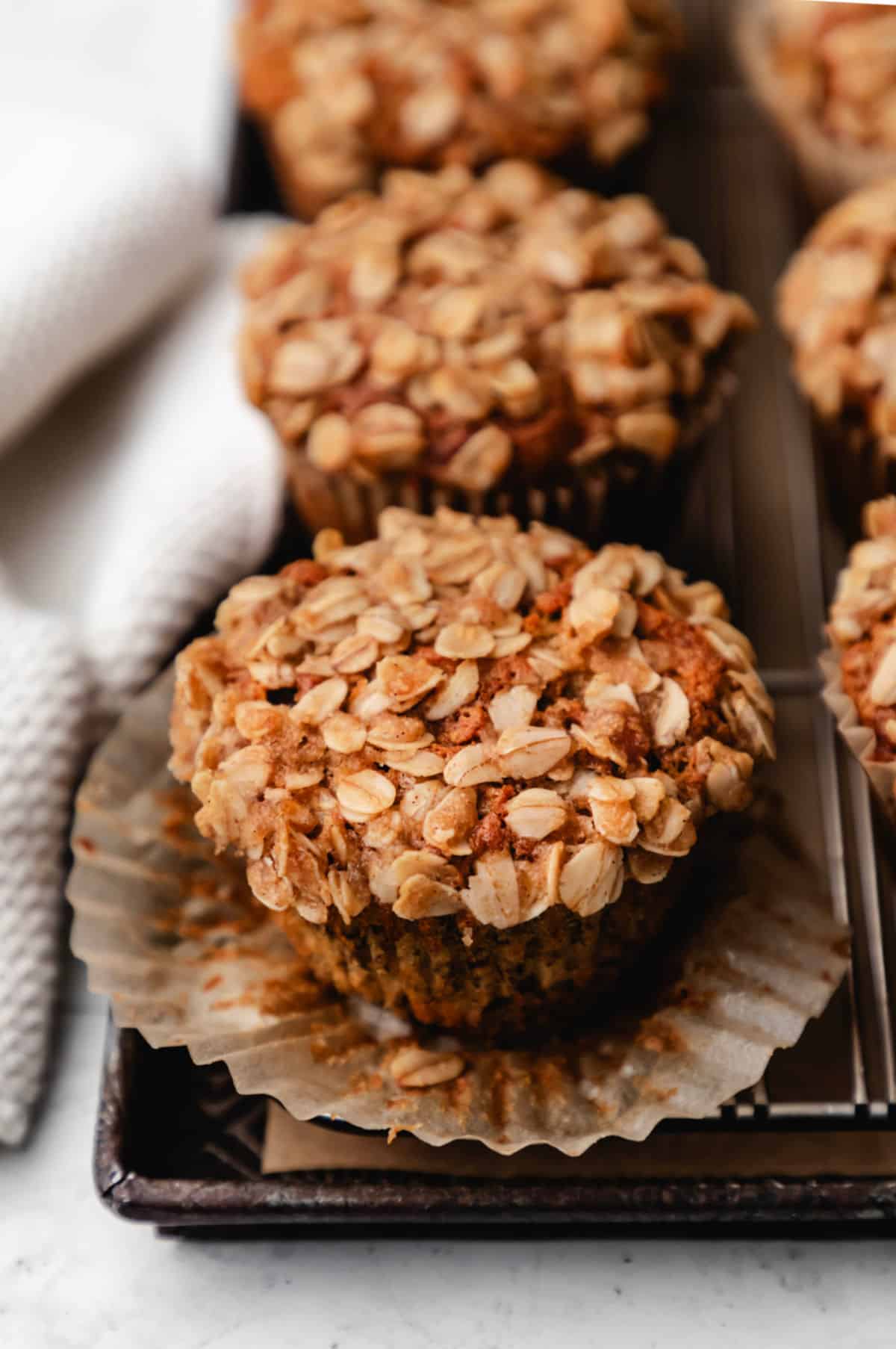 A banana oatmeal muffin with the wrapper turned down.