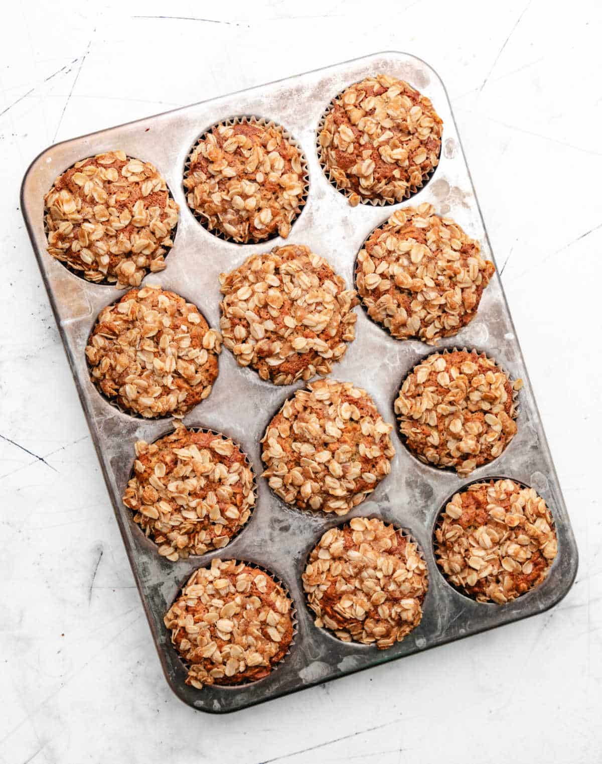 Banana oatmeal muffins in a silver muffin tin.