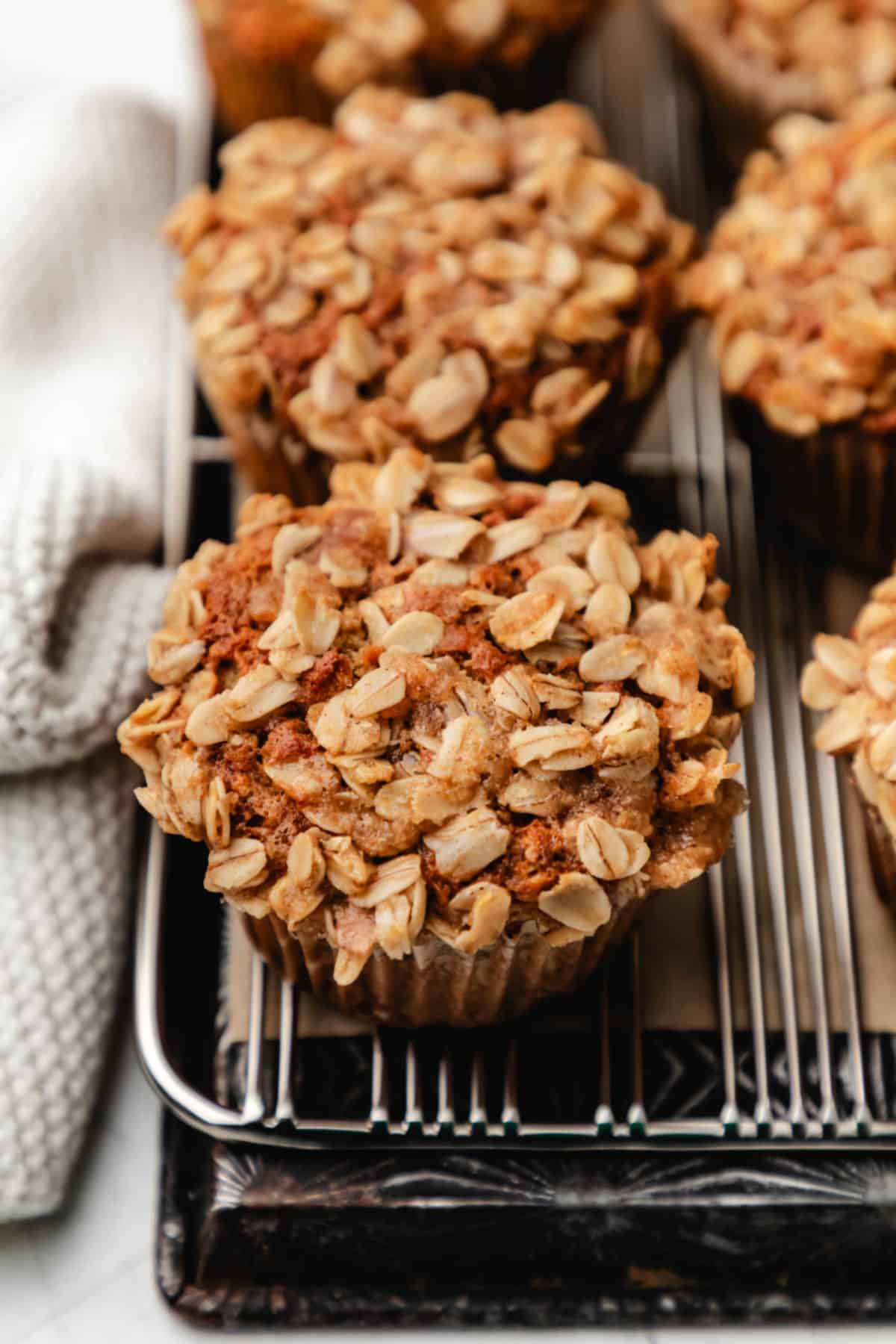 Banana oatmeal muffins in a row on a cooling rack.