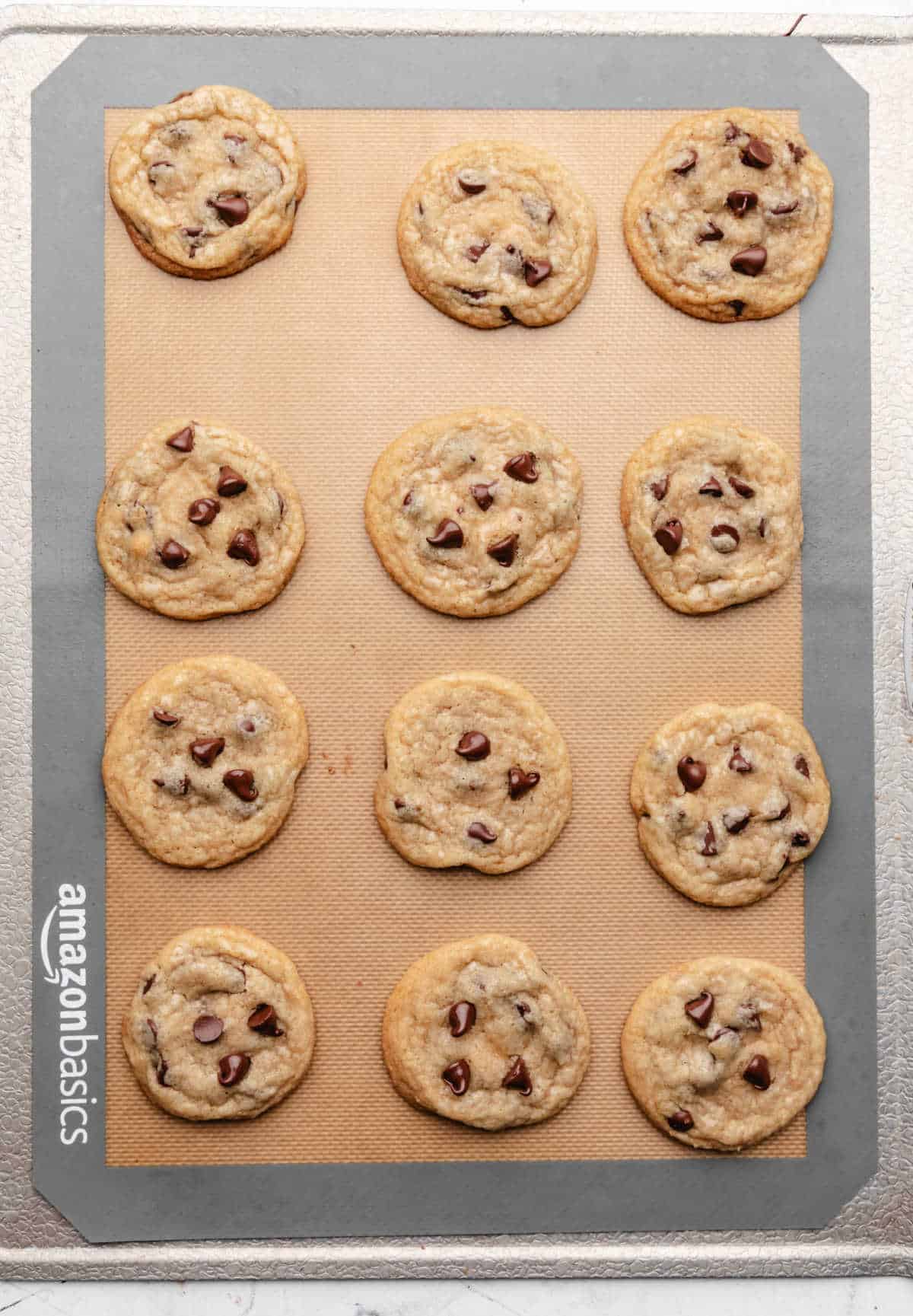 Baked coconut oil chocolate chip cookies on a baking sheet.