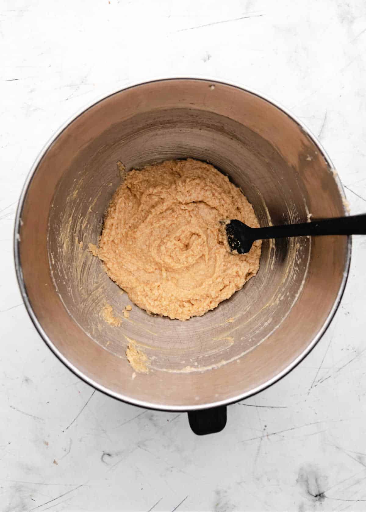 Eggs beaten into creamed coconut oil and sugar mixture. 