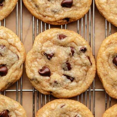 Coconut oil chocolate chip cookies on a wire cooling rack.