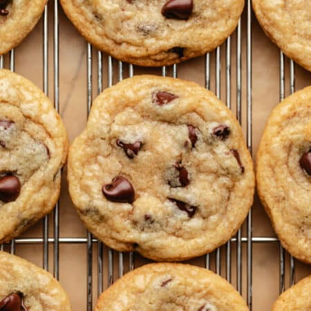 Coconut oil chocolate chip cookies on a wire cooling rack.