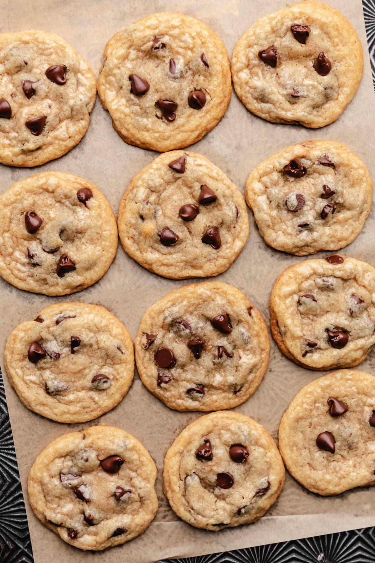 Coconut oil chocolate chip cookies on a sheet of brown parchment paper.