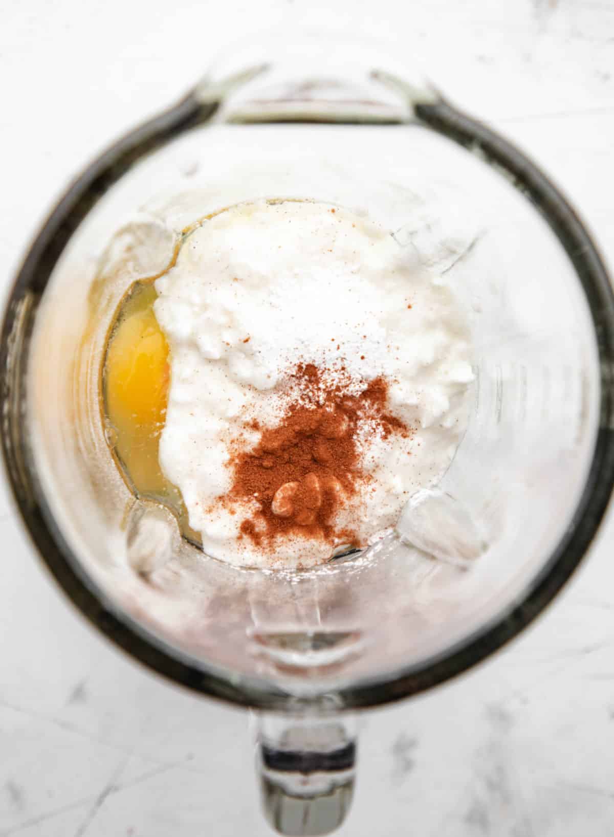 Ingredients for cottage cheese pancakes in a blender. 