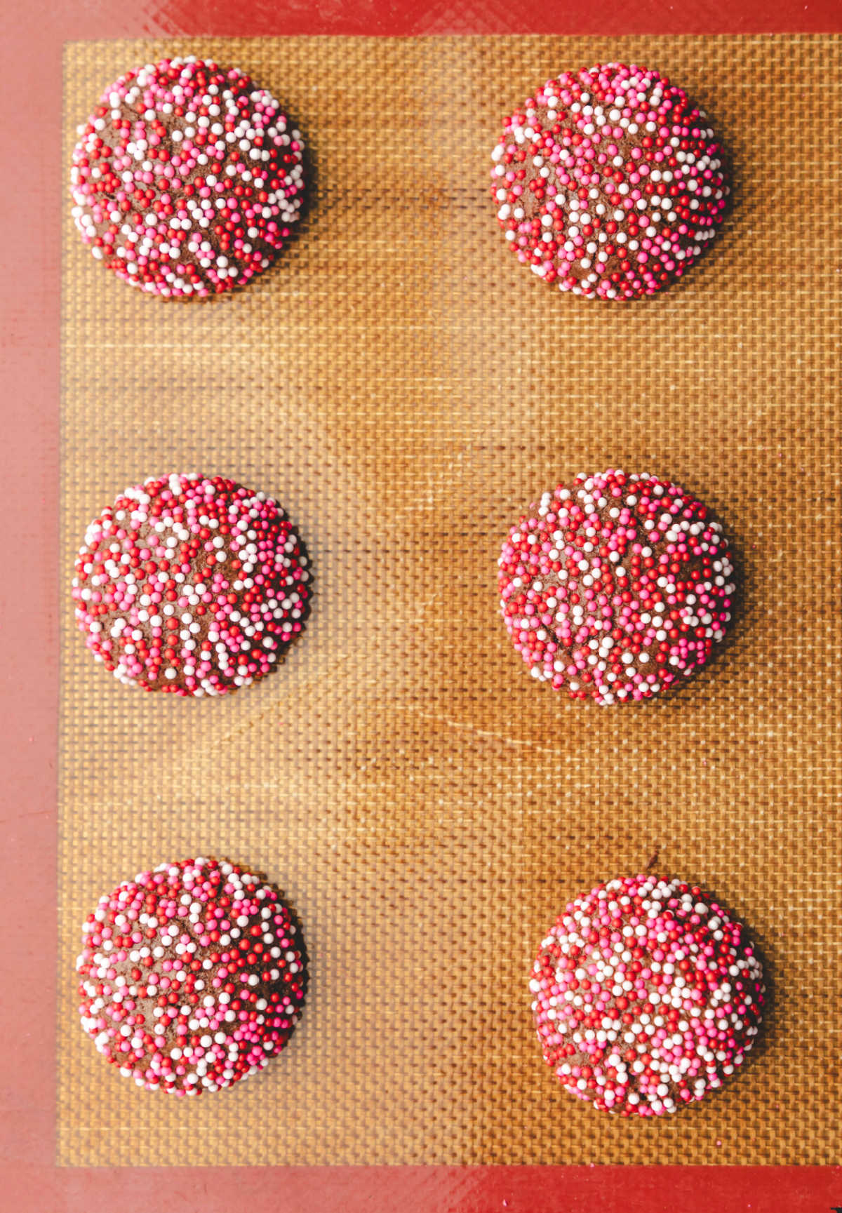 Baked Valentine's Day cookies on a baking sheet. 