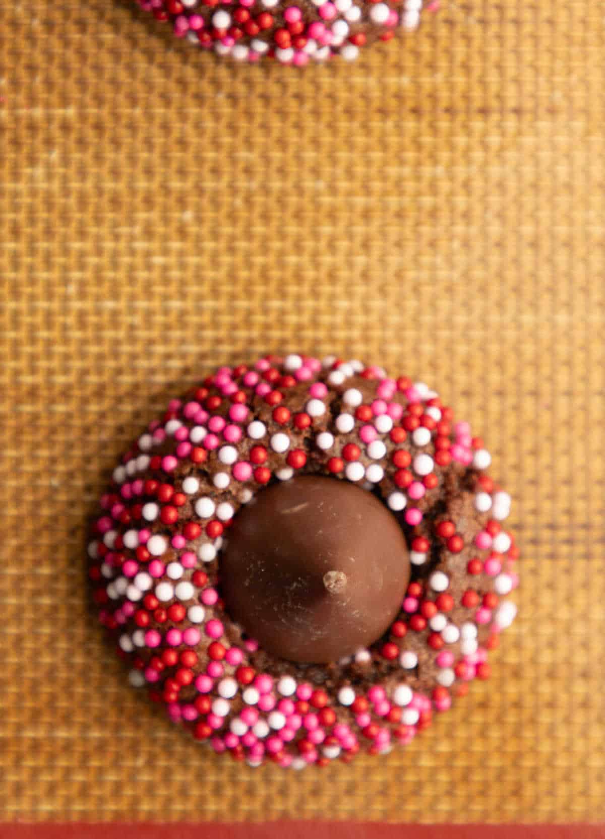 A Valentine's Day kiss cookie on a baking sheet.