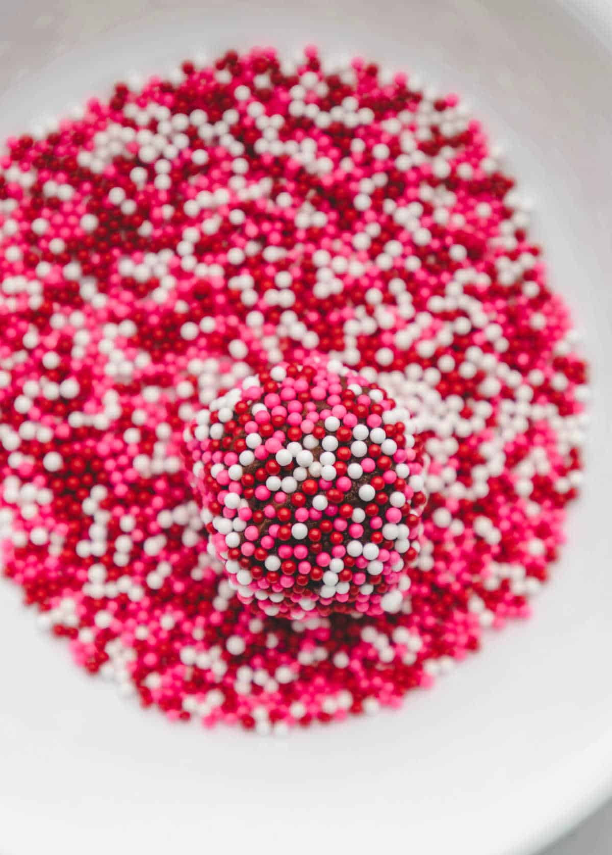 A scoop of chocolate cookie dough in sprinkles.