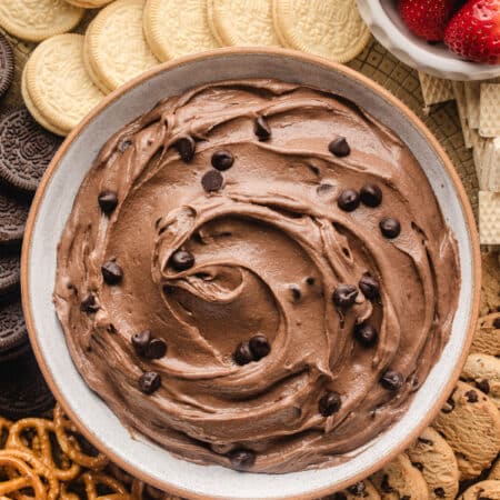 A dish of brownie batter dip topped with mini chocolate chips.