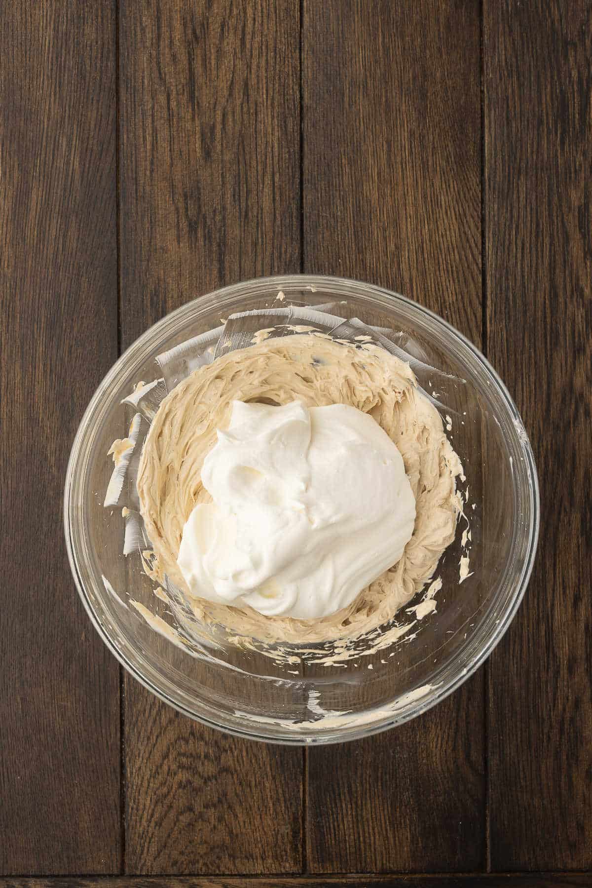 Cool whip on top of beaten cream cheese mixture.