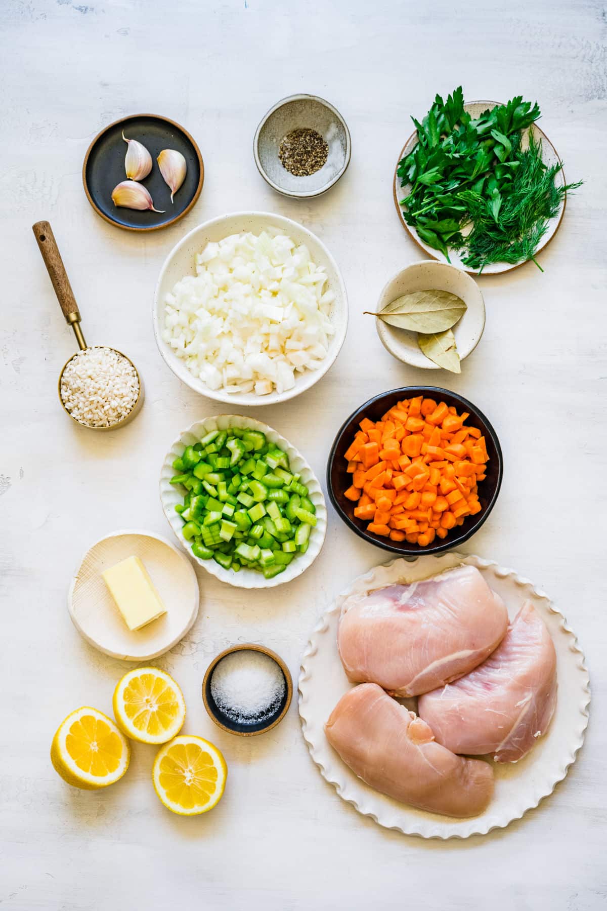 Ingredients for lemon chicken and rice soup in dishes.