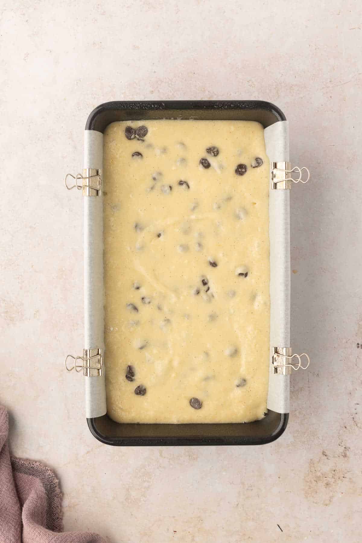Chocolate chip loaf cake batter in a loaf pan.