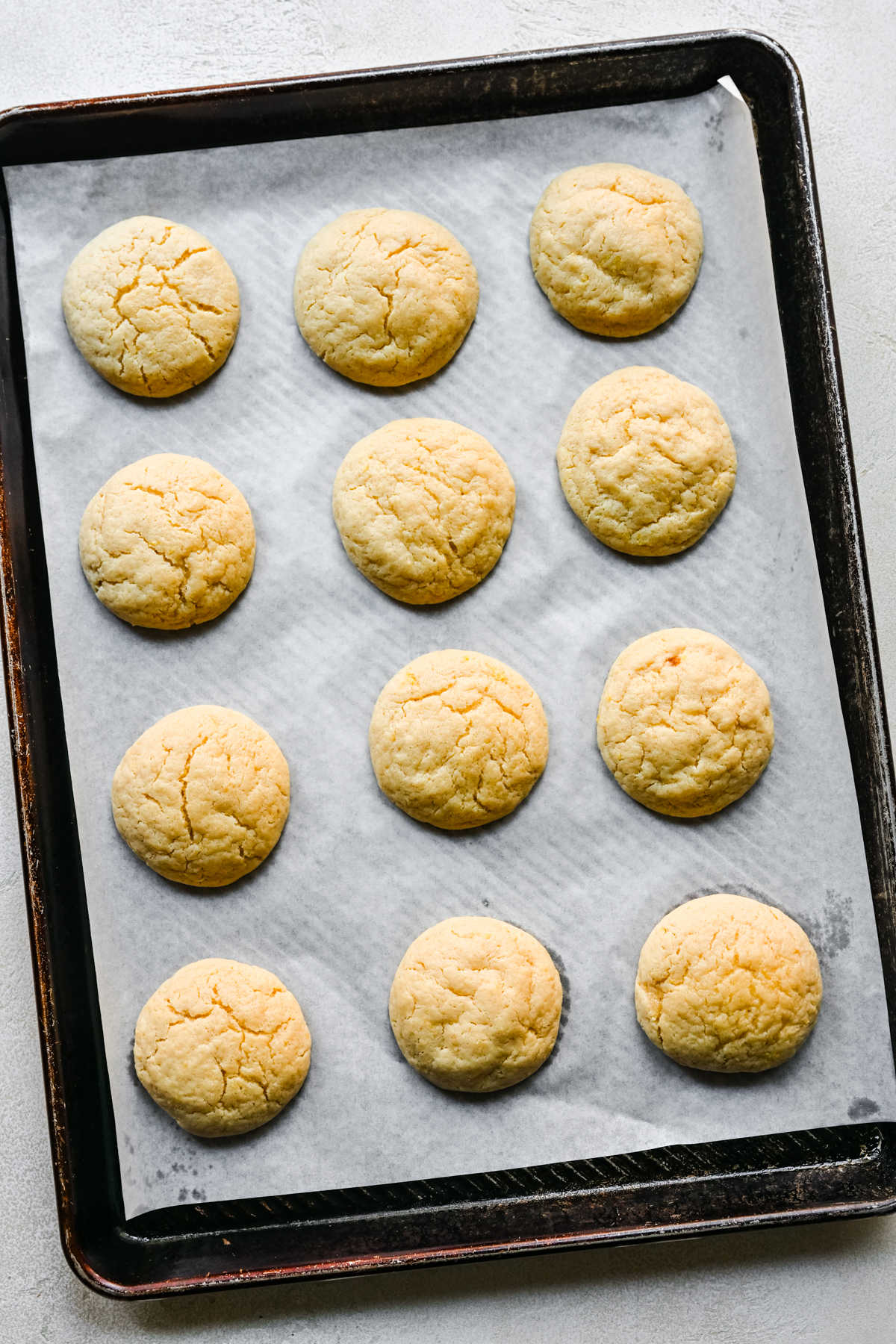 Baked lemon sugar cookies on a baking tray.