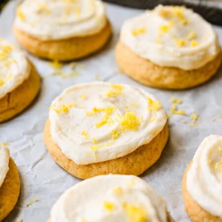 Frosted lemon sugar cookies topped with fresh grated lemon zest.