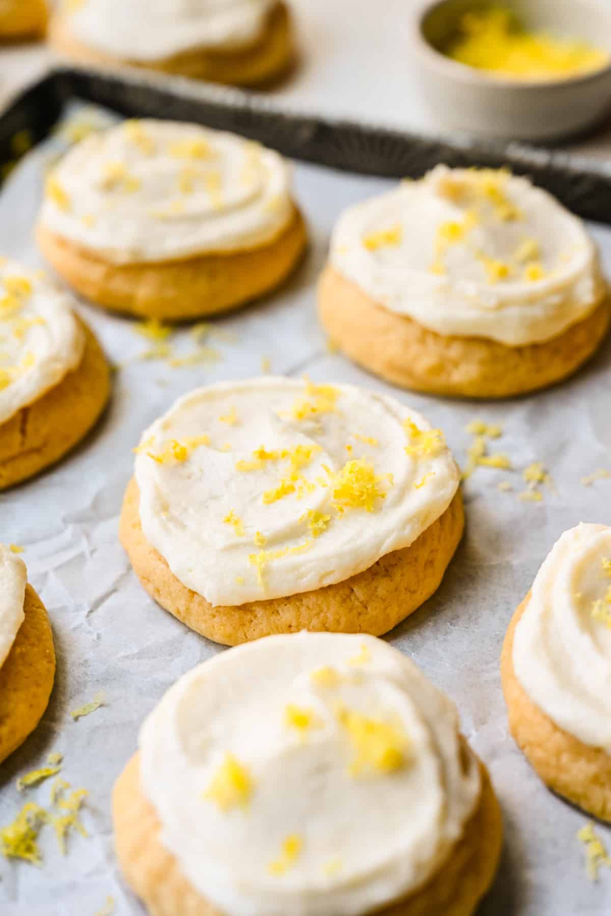 Frosted lemon sugar cookies topped with fresh grated lemon zest.