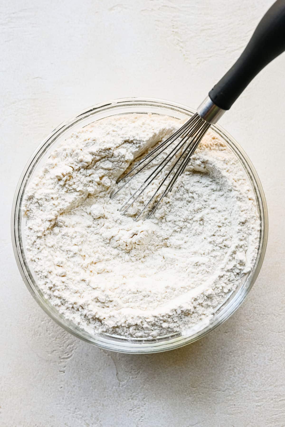 Dry ingredients for lemon sugar cookies in a bowl. 