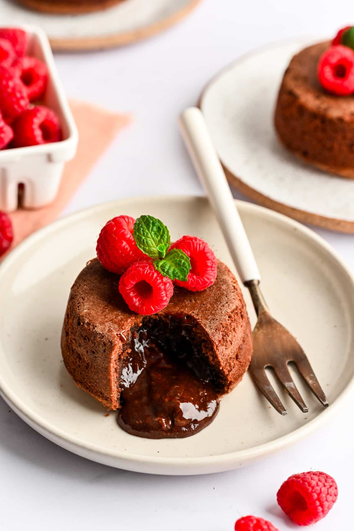 A Nutella molten lava cake with Nutella coming out of the open section. 