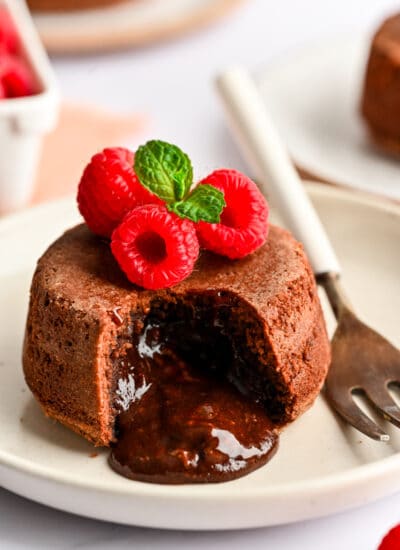 A Nutella molten lava cake on a white plate next to a fork.
