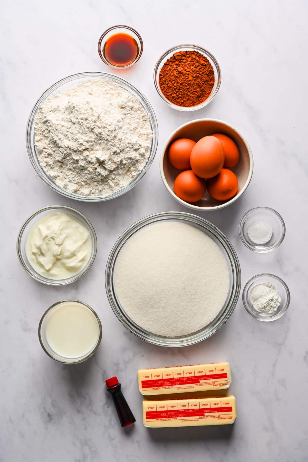 Ingredients for red velvet marble cake in dishes. 