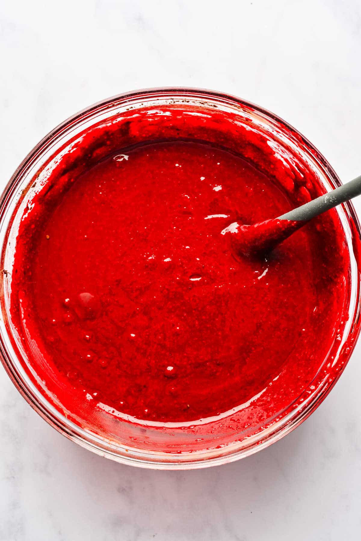 Red velvet marble cake batter in a mixing bowl. 