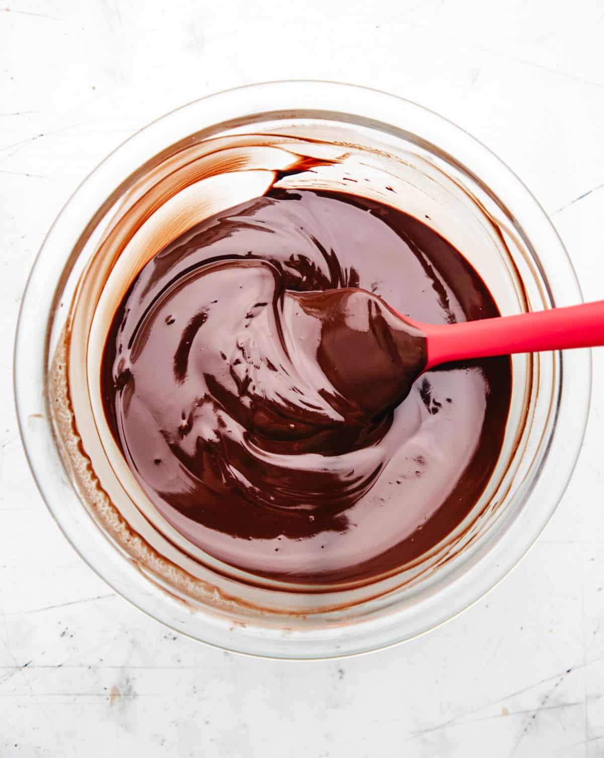 Melted butter and chocolate in a glass mixing bowl. 