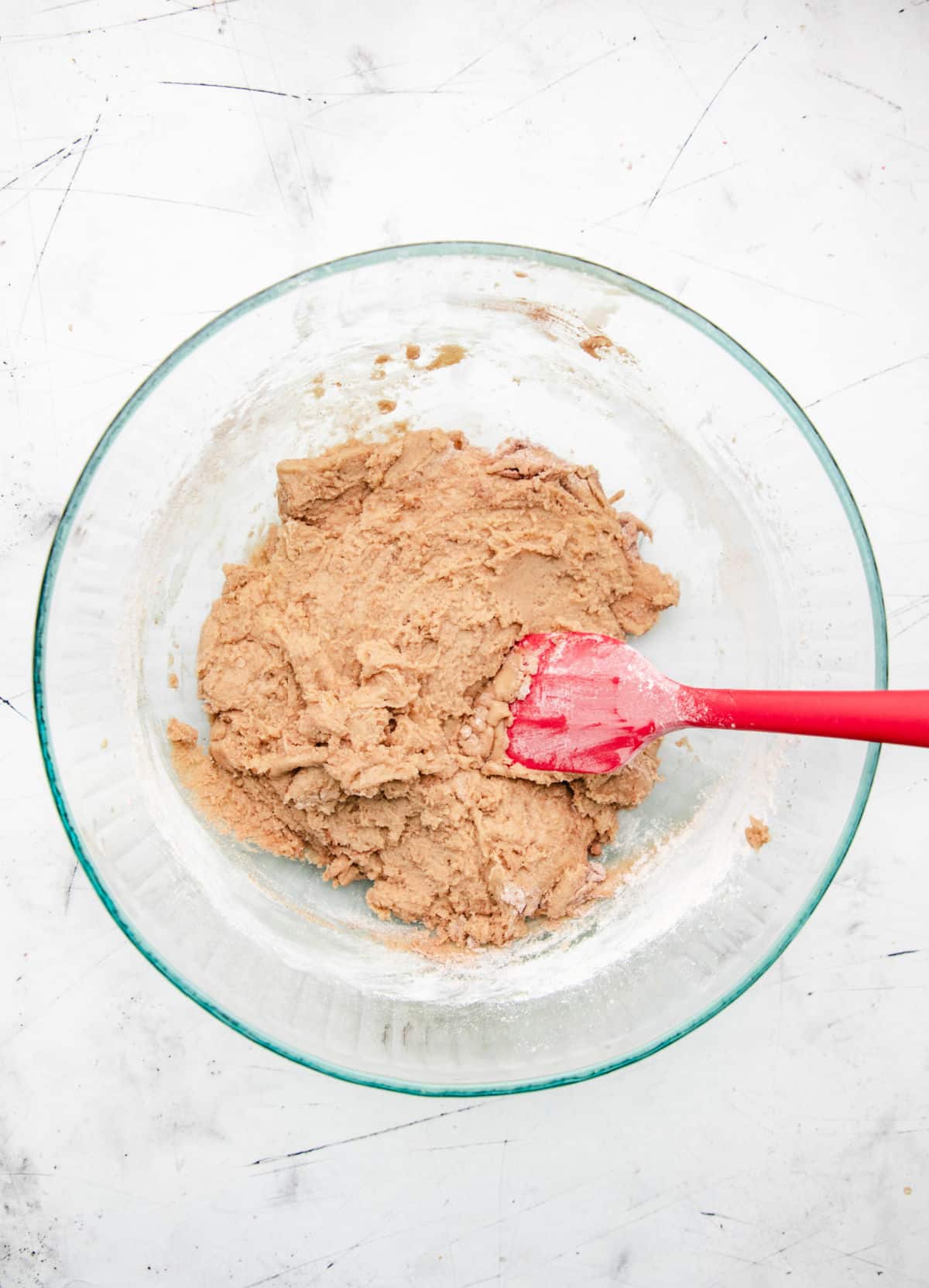 Dry ingredients stirred into wet ingredients for carrot cake cookies.